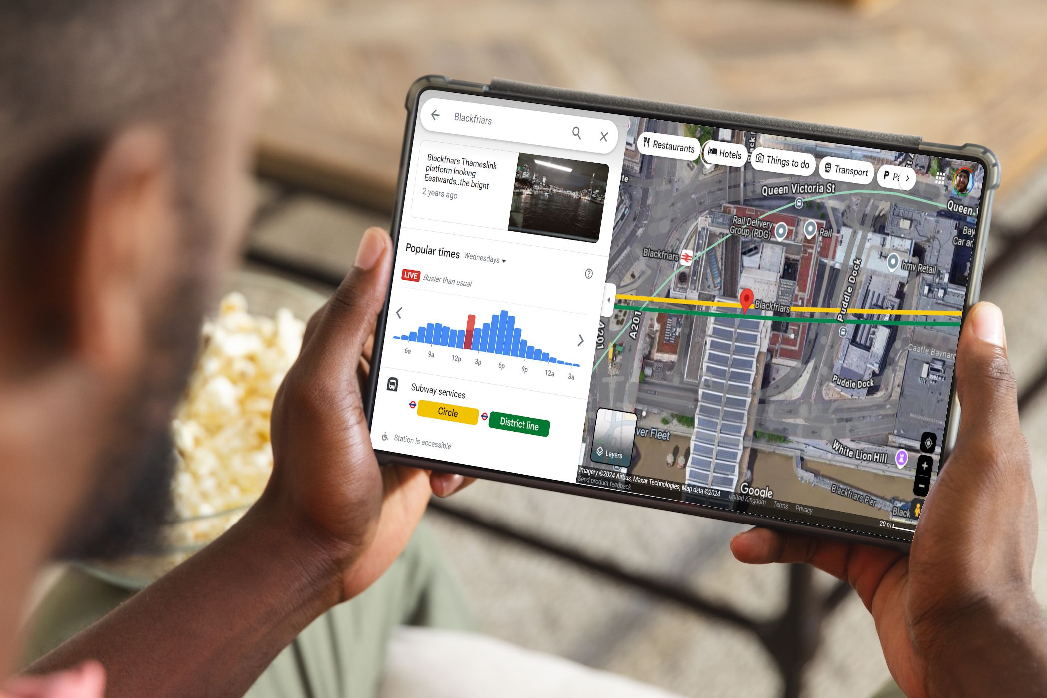 man looking at google maps on tablet