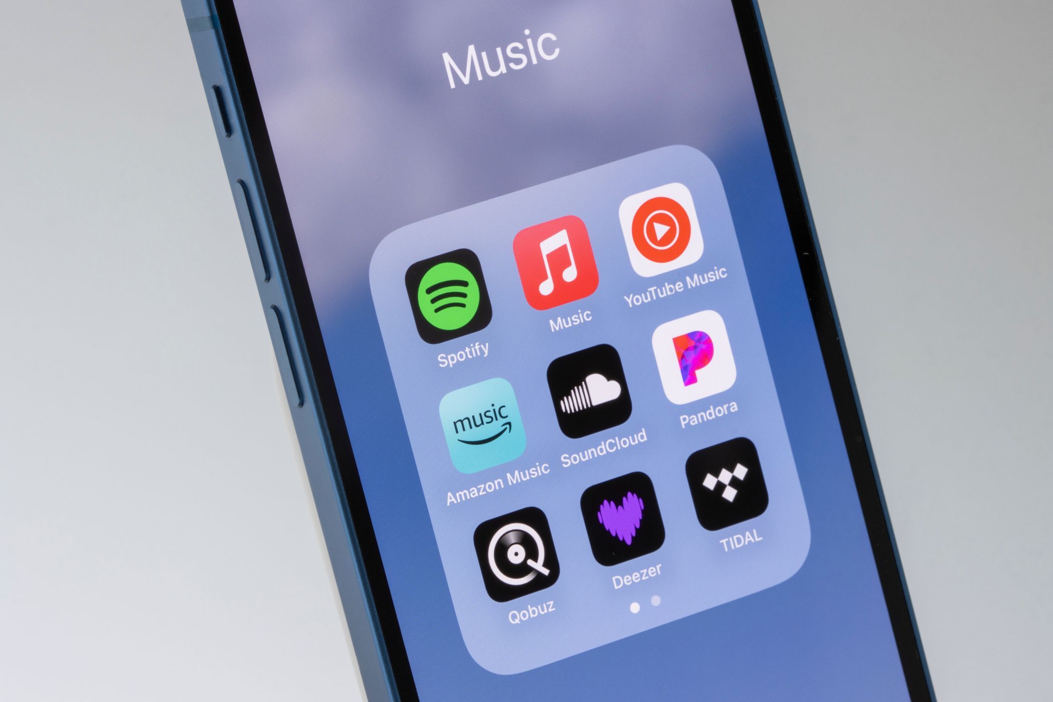 Modern smartphone screen displaying various music streaming apps representing the digital shift in music consumption