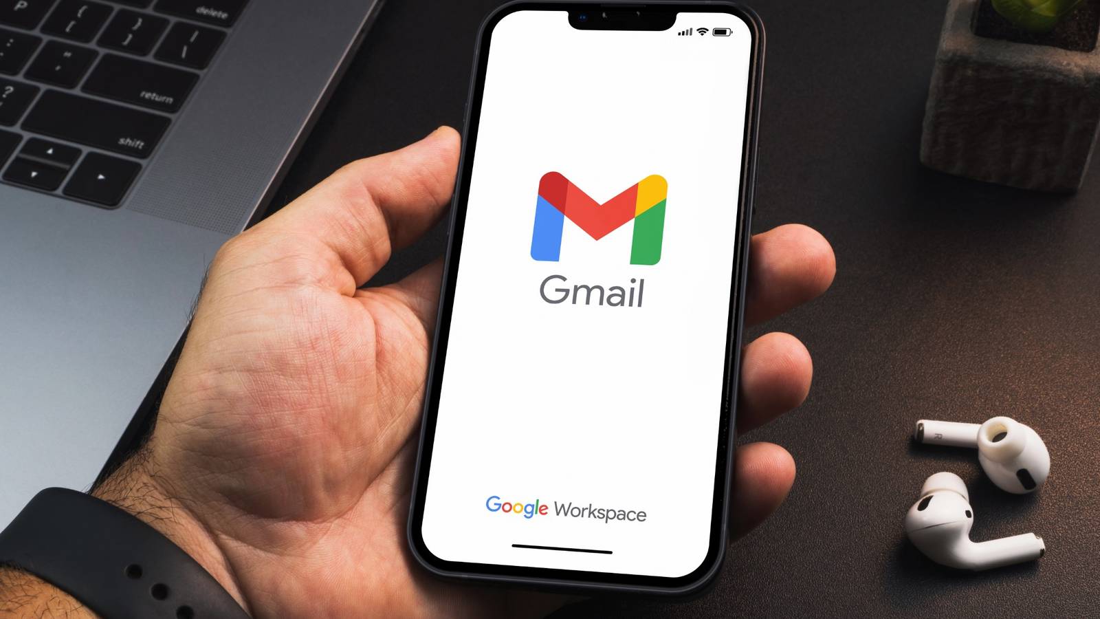 Person holding a phone with Gmail open on it