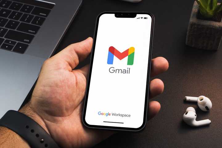 Person holding a phone with Gmail open on it