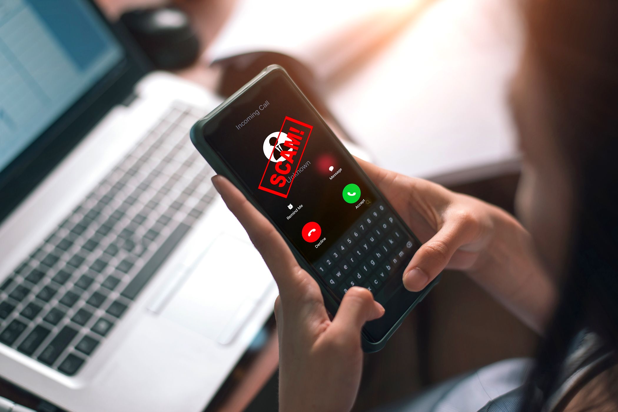 woman answering smartphone call with scam alert