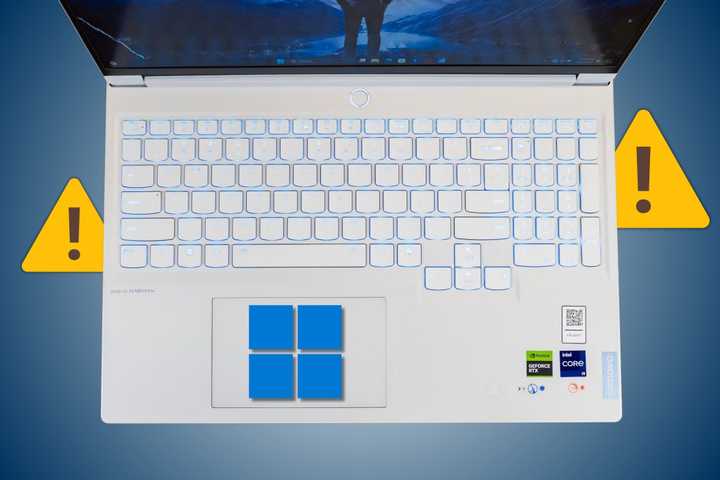 Backlit keyboard on a Lenovo Legion laptop with error and Windows icon