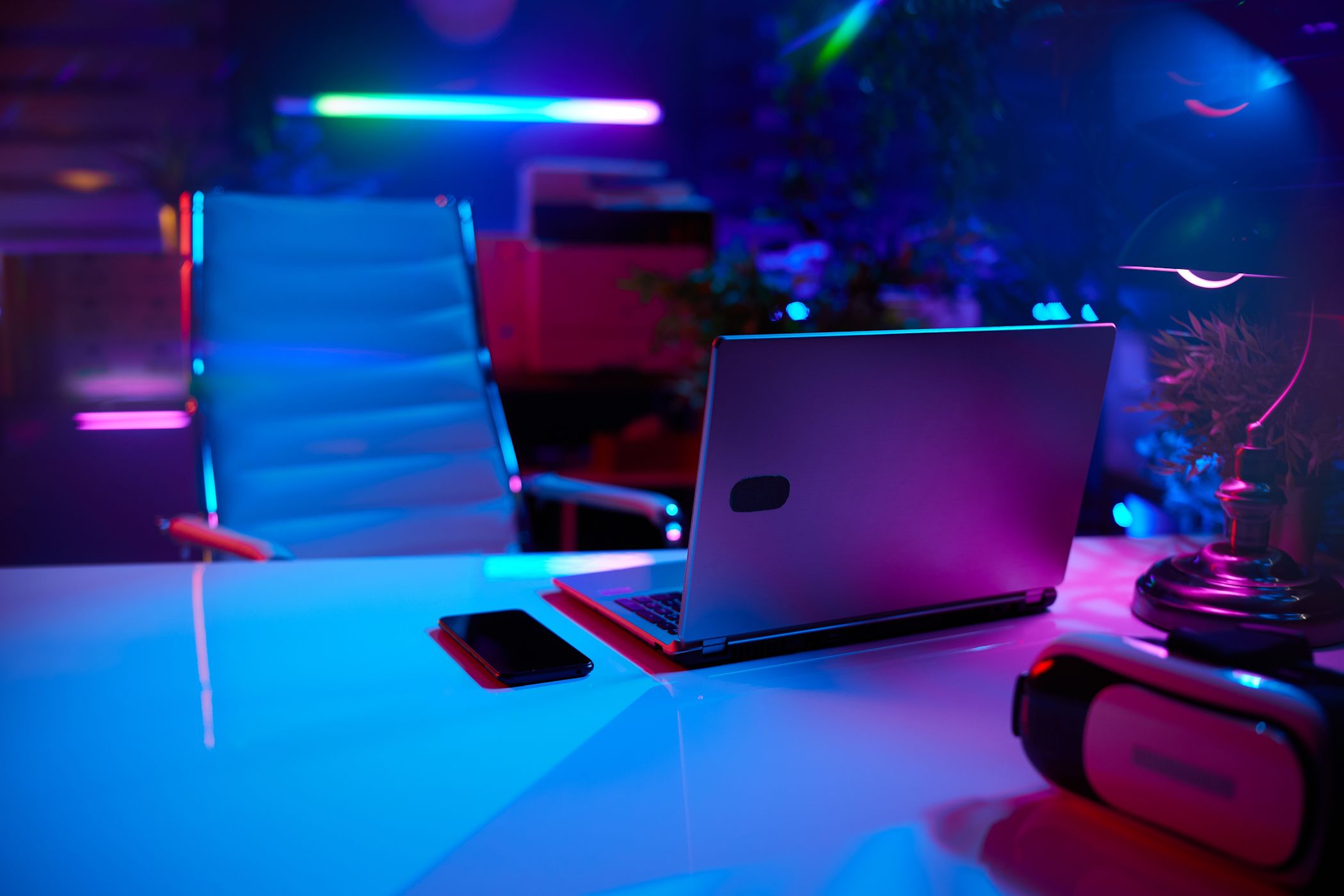 gaming laptop under neon lights in office