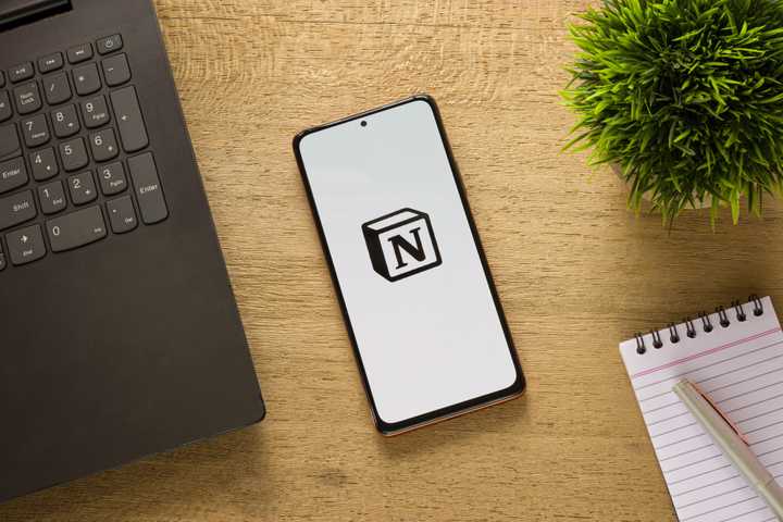 Phone on a desk showing the Notion logo