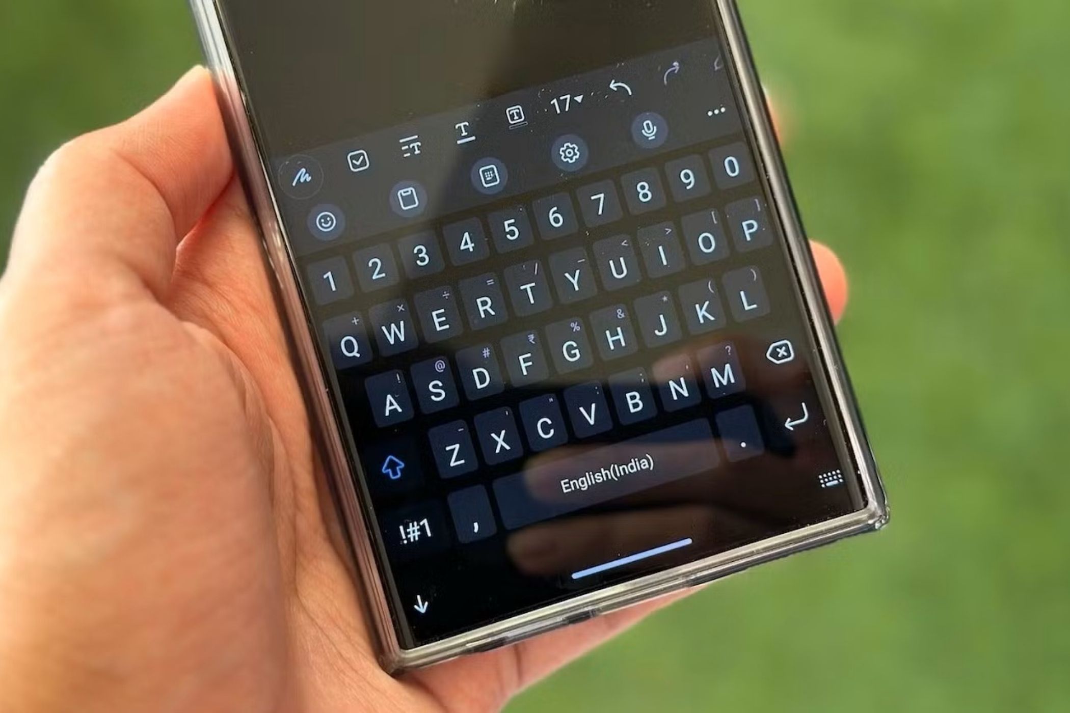 Close up of Galaxy phone in hand showing keyboard