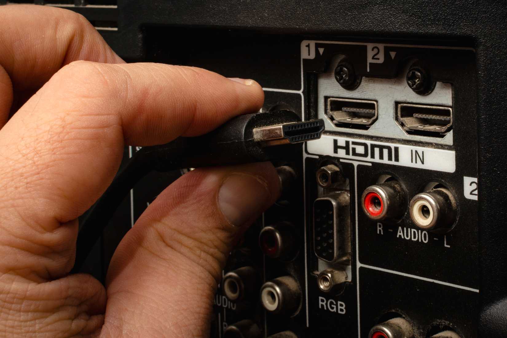 hdmi cable inserting into back of tv hdmi port