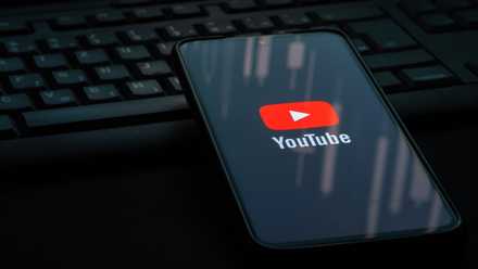 YouTube Logo on Smartphone resting on a keyboard