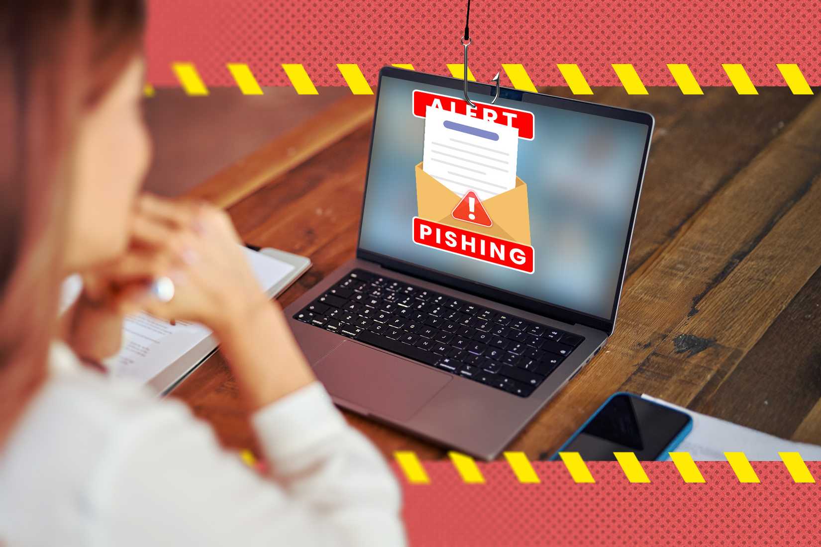 A woman using a laptop with a phishing email on the screen.