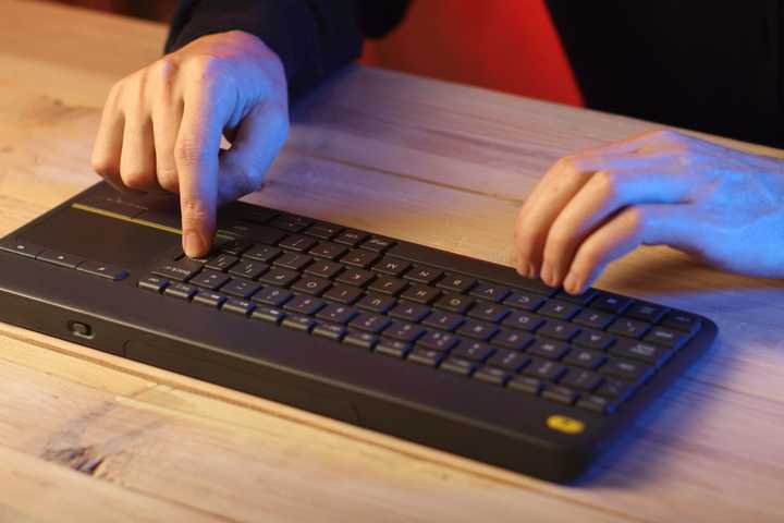 Hands Typing on Wireless Keyboard
