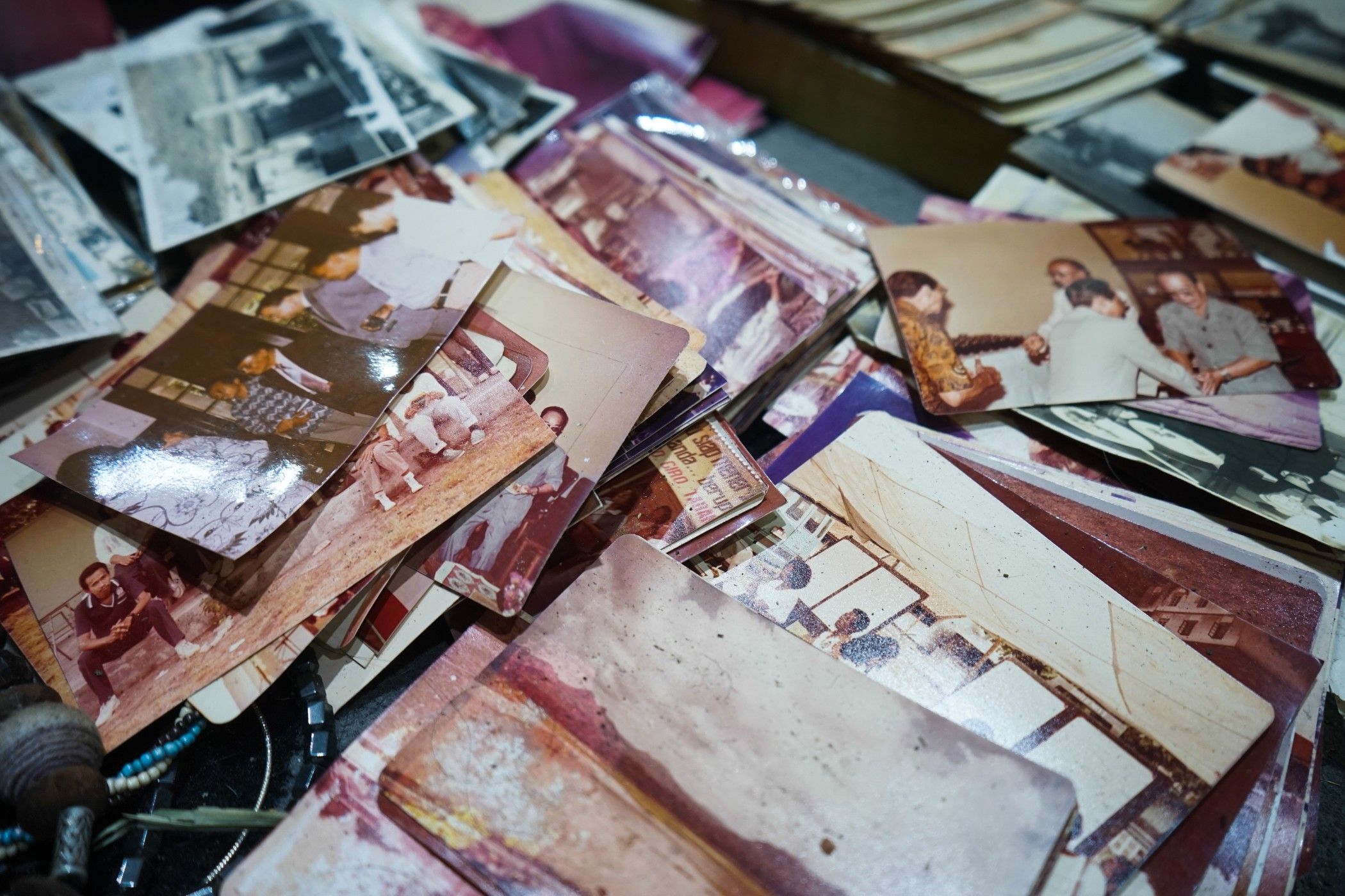 Old photos cluttered on a desk
