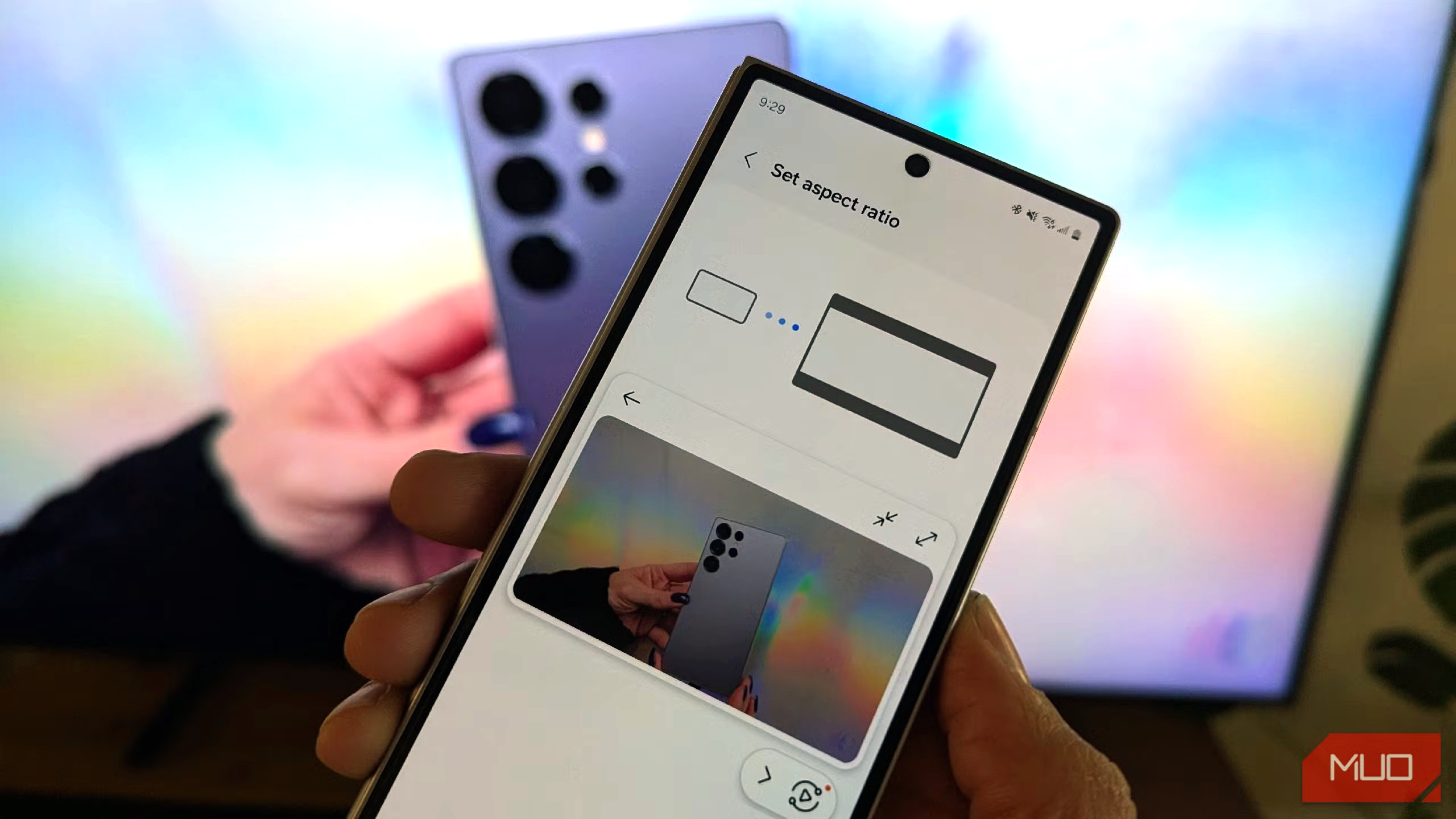 person taking photo of smartphone with aspect ratio sizing settings