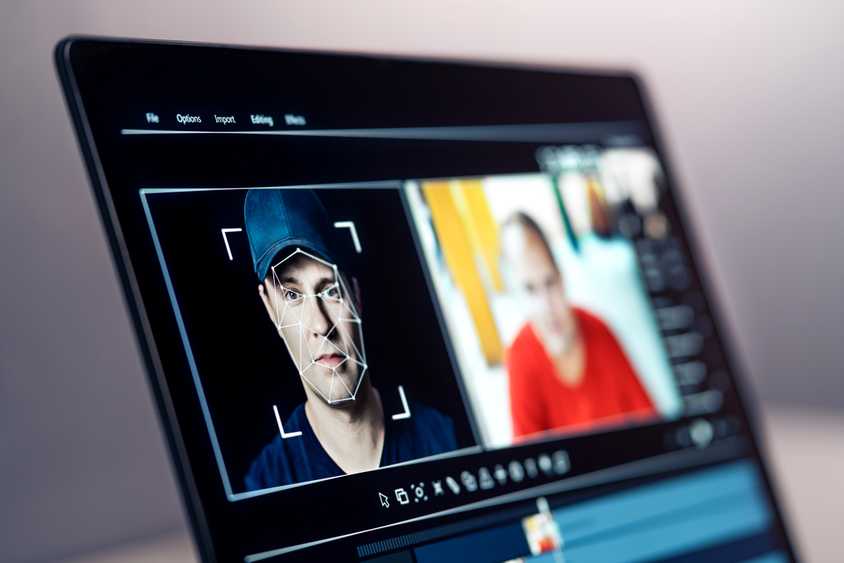 deepfake software analyzing face on laptop screen.