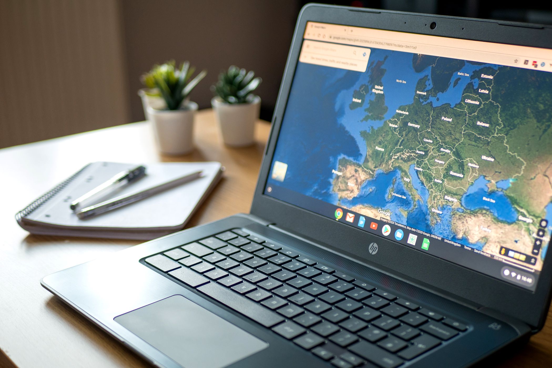hp chromebook on table showing google maps.