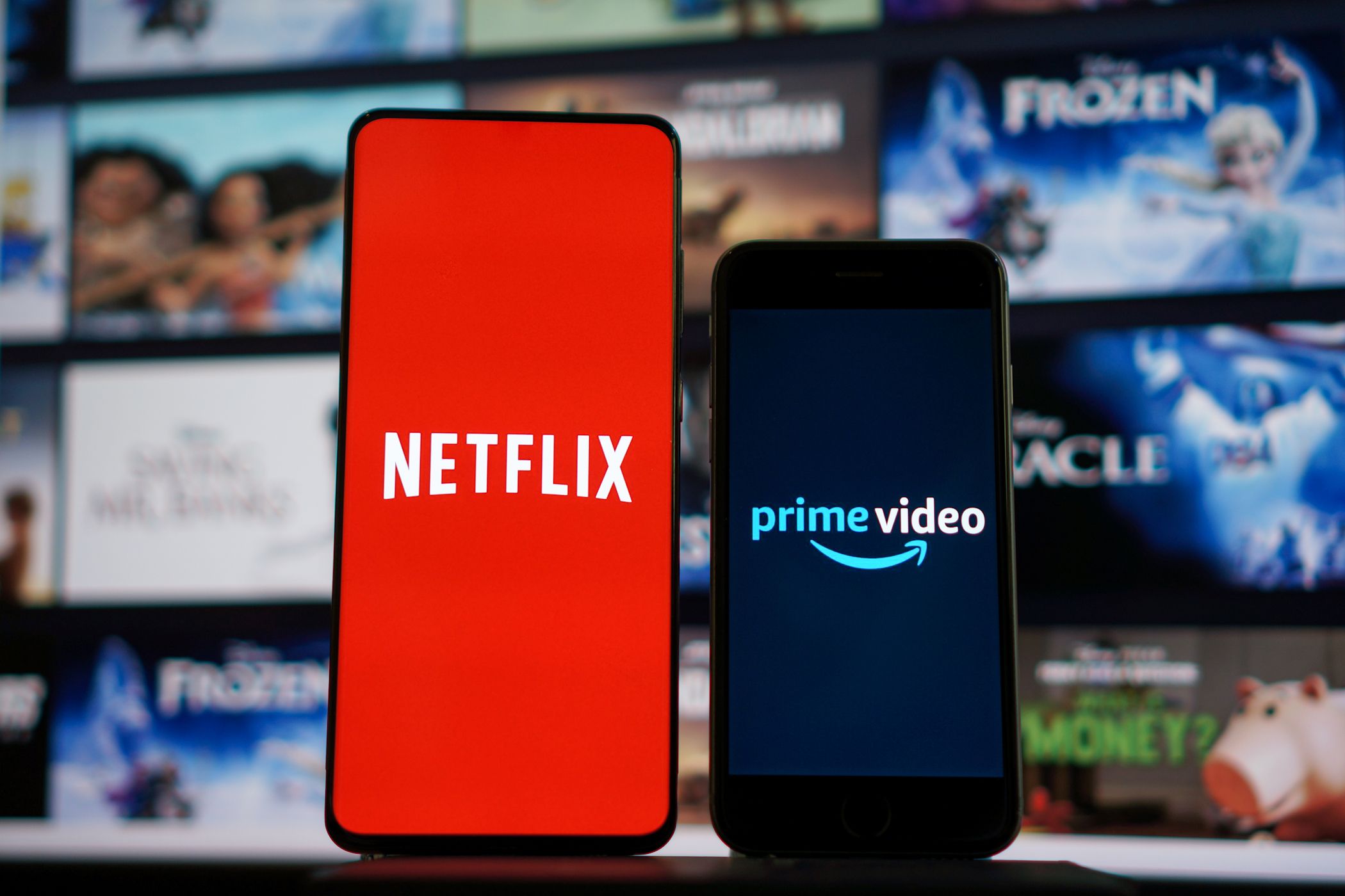netflix and prime video logos on smartphone screens.