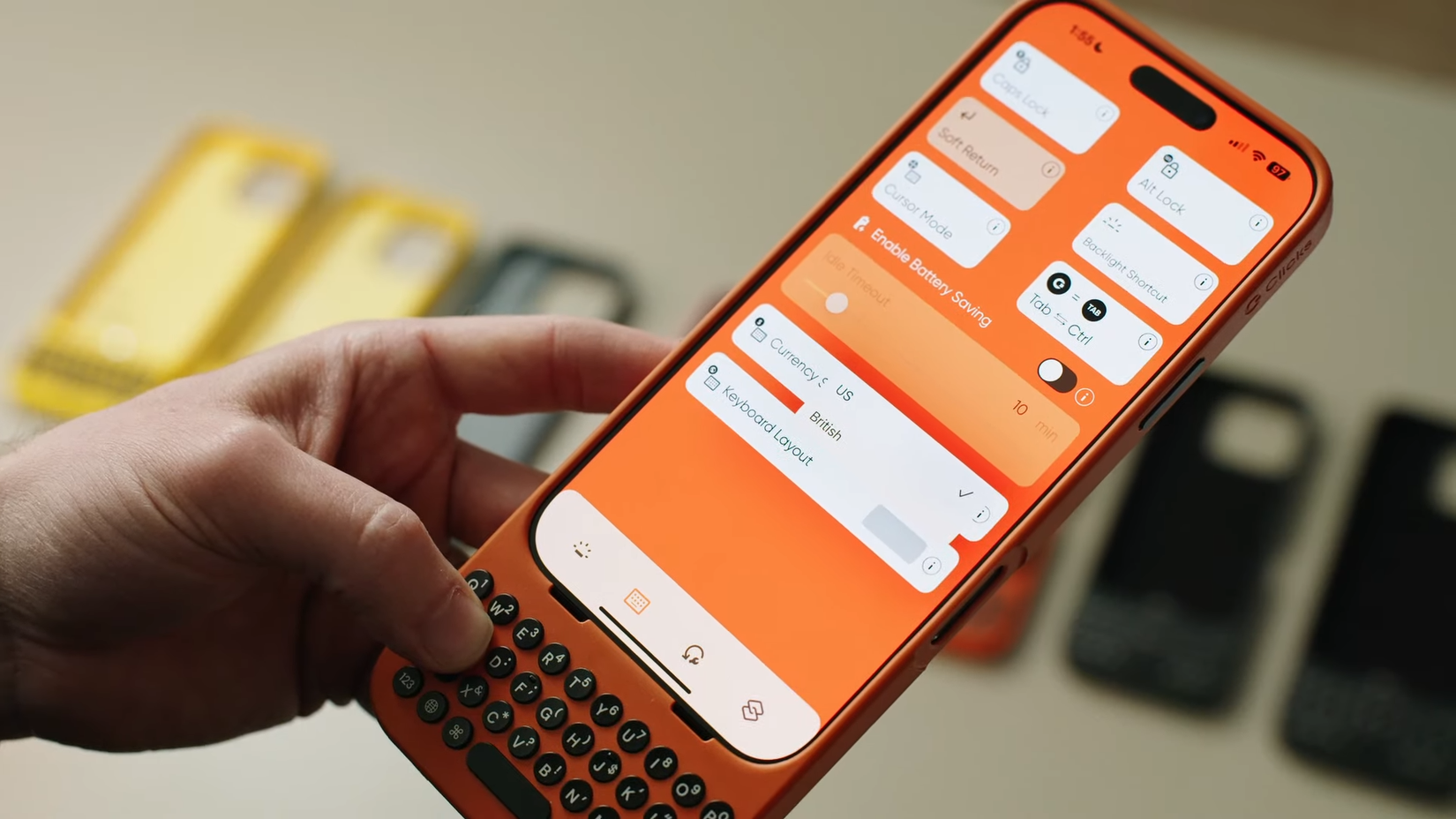 A hand holding an iPhone with Clicks Keyboard case