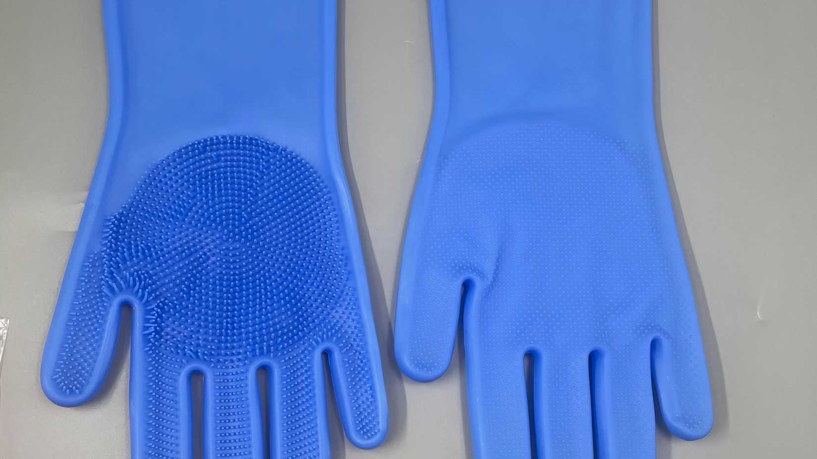 A pair of reuseable cleaning gloves in blue. 