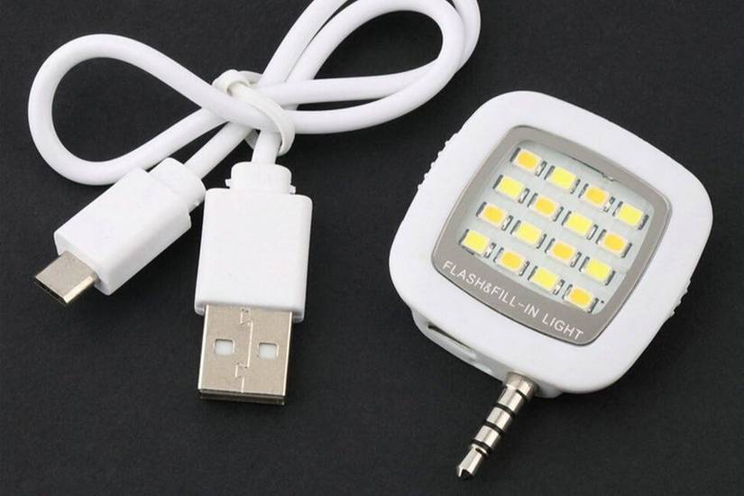 Portable flash light with USB cable next to it