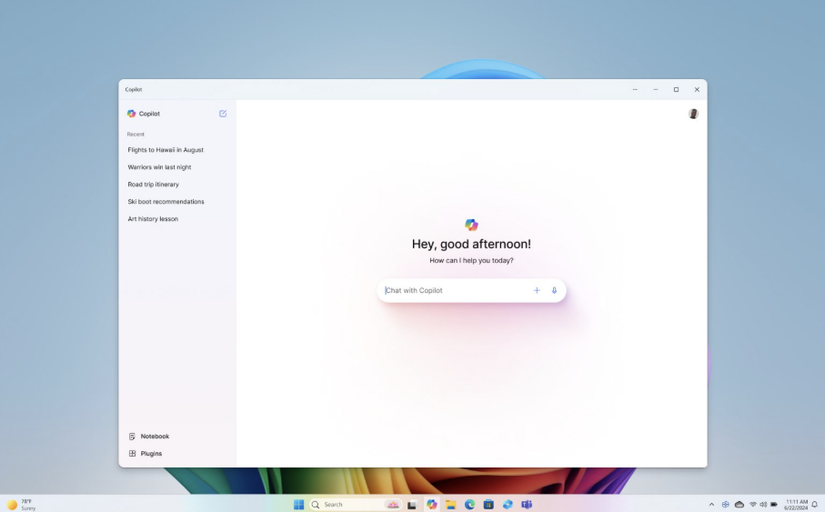 Windows Copilot app open on desktop with greeting and chat input box.