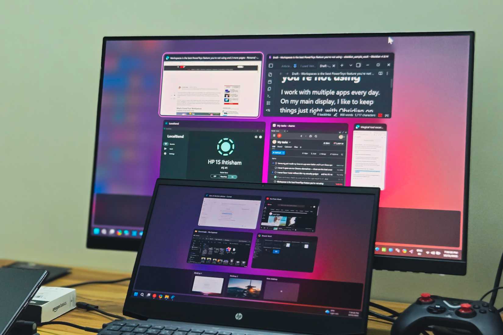 An HP Laptop and a BENQ monitor dual display setup kept on a wooden table