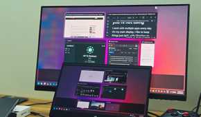 An HP Laptop and a BENQ monitor dual display setup kept on a wooden table