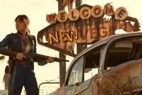 Ella Purnell (Lucy MacLean) in FALLOUT SEASON 2 standing in front of New Vegas sign