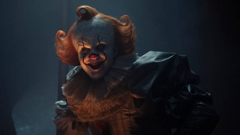 Pennywise from Welcome to Derry smiling creepily.