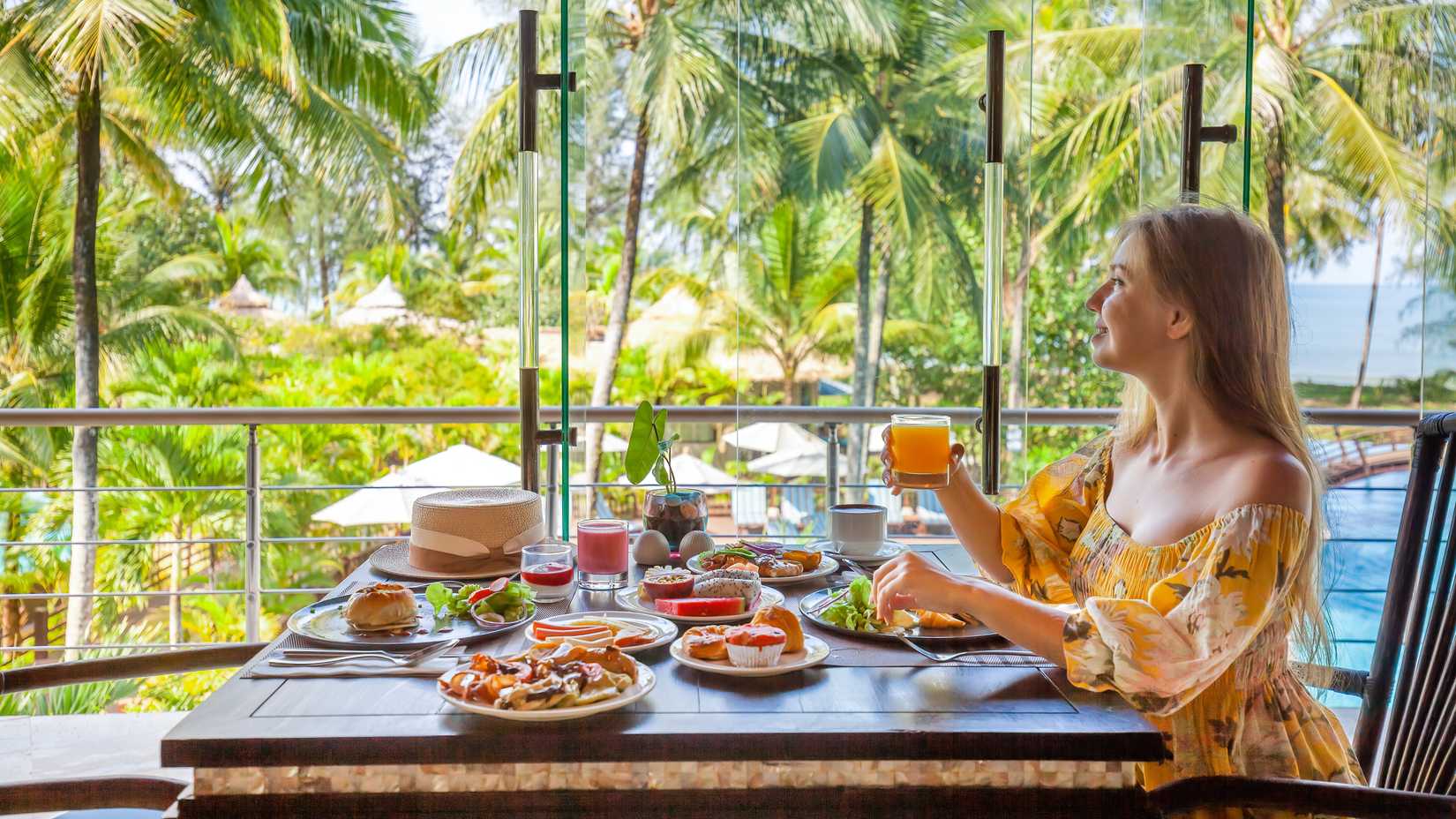 yesim woman dining in a tropical location