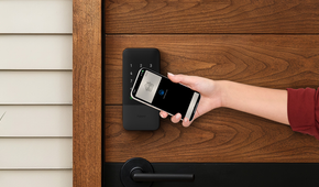 Person unlocking the Aqara Smart Lock U400 with their phone.