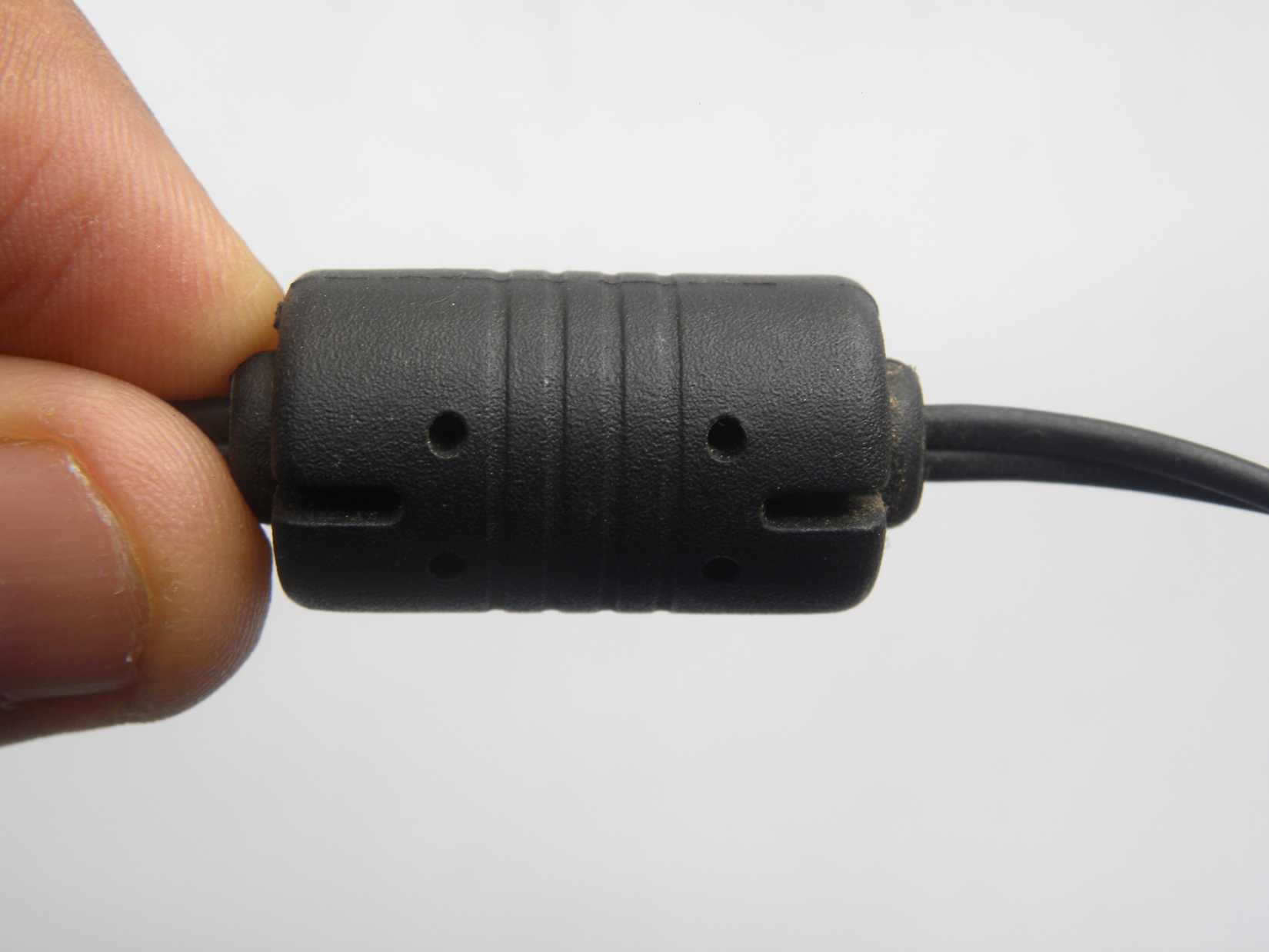 Man holding cable with ferrite core