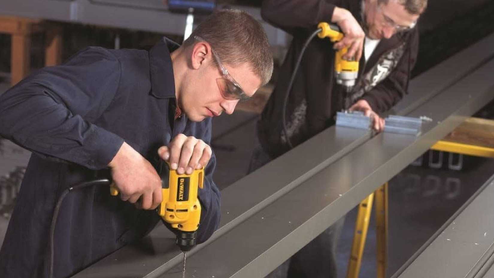 Men using a DEWALT corded drills