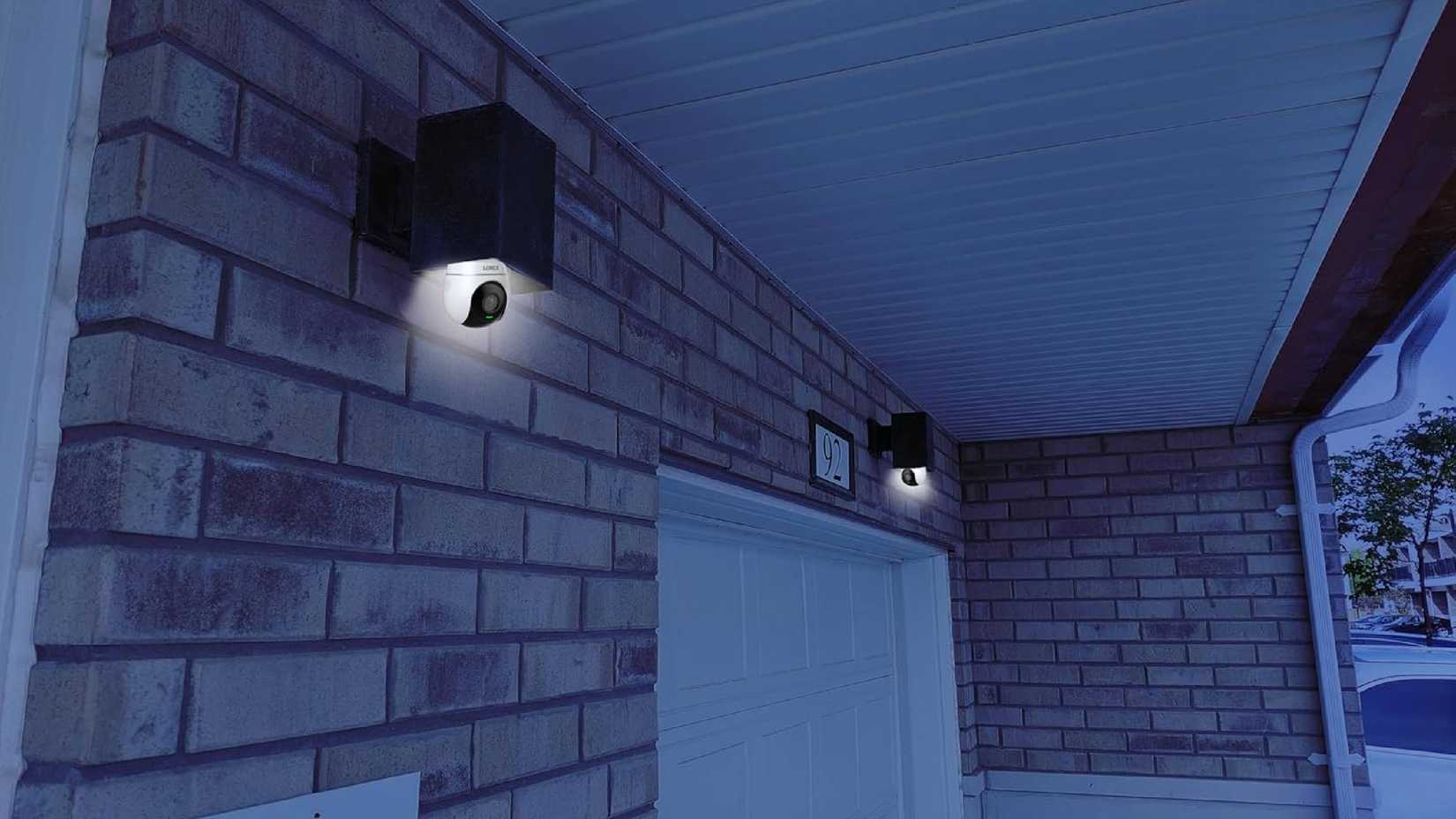 Two Lorex Connect 2K Wi-Fi Smart Lightbulb Pan-Tilt Cameras outside a home