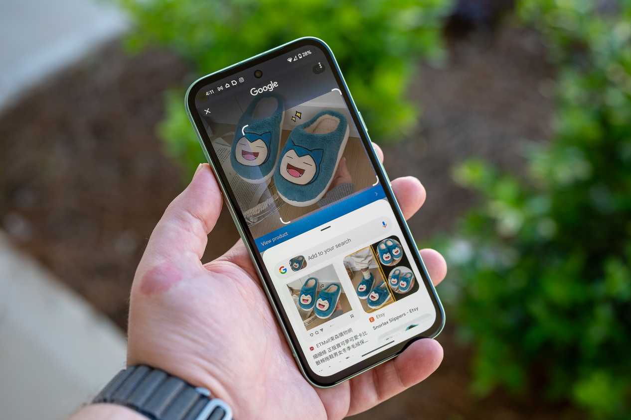 Person holding the Google Pixel 8a using Circle to Search