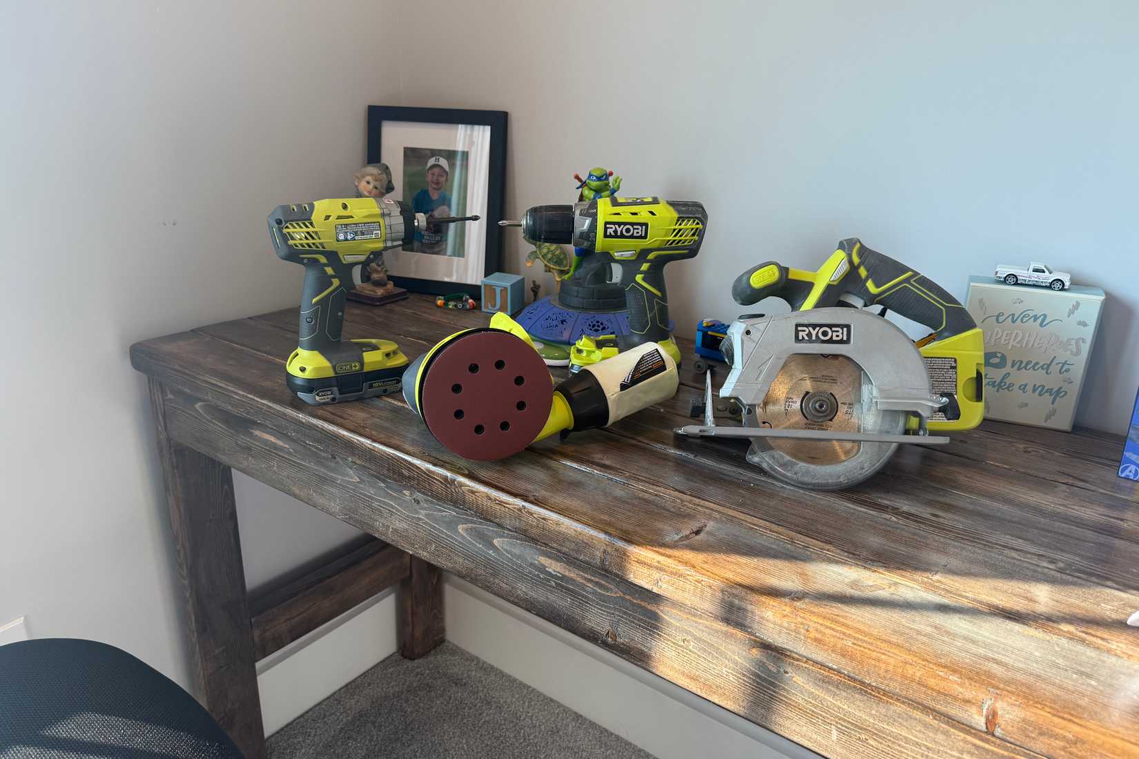 4 ryobi power tools on wooden desk