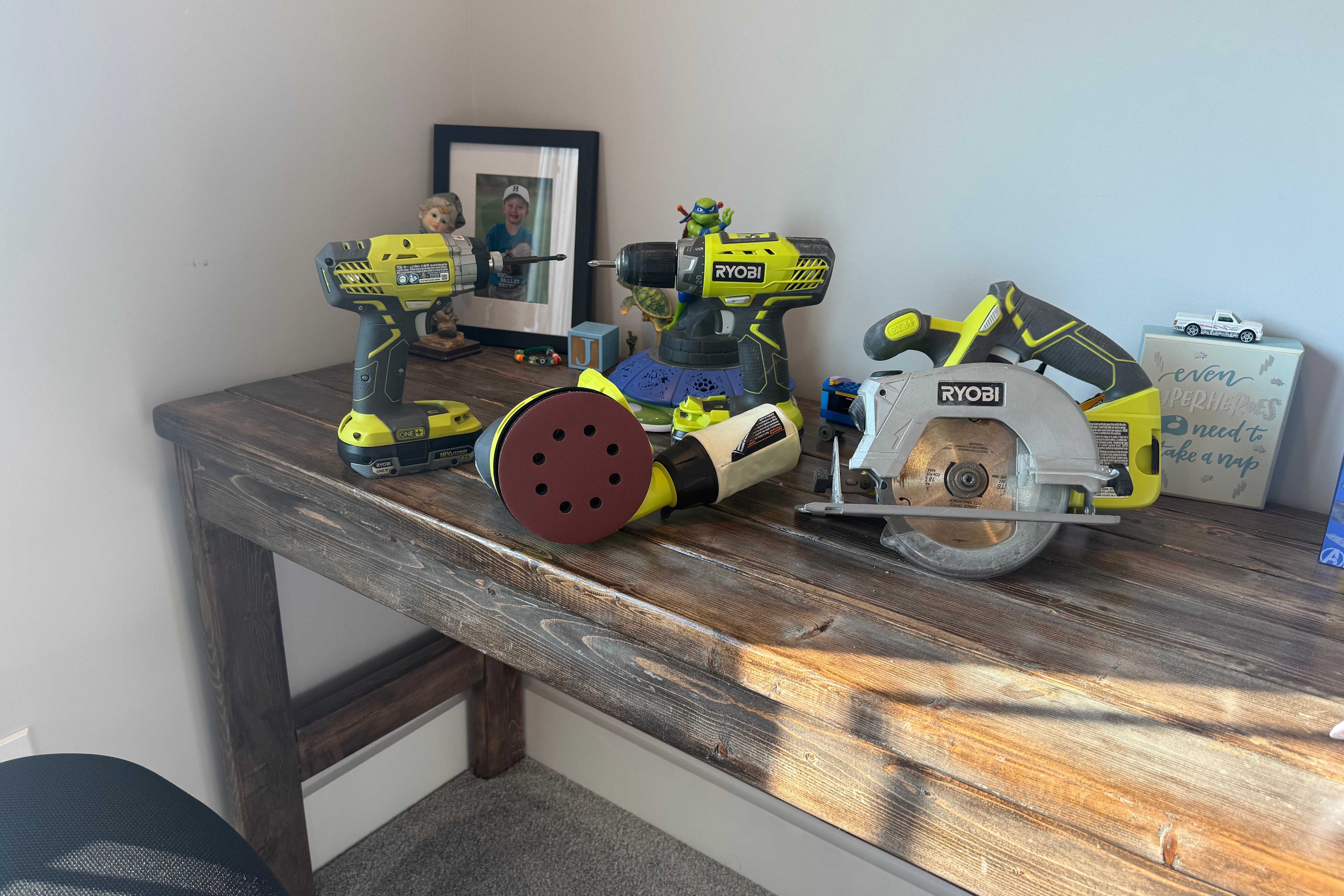 4 ryobi power tools on wooden desk