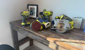 4 ryobi power tools on wooden desk
