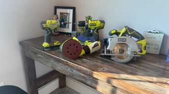 4 ryobi power tools on wooden desk
