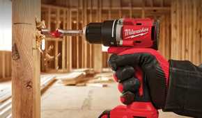 A person using a drill to drill in a hole