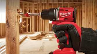 A person using a drill to drill in a hole
