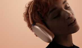 A woman with her eyes closed wearing the Apple AirPods Max 2.