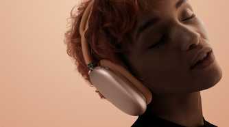 A woman with her eyes closed wearing the Apple AirPods Max 2.