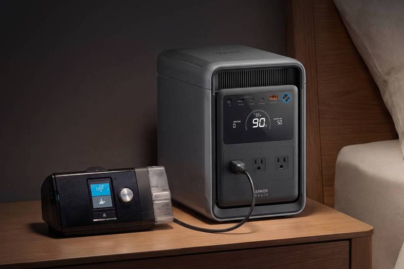 Anker SOLIX S2000 sitting on a bedside table next to a medical machine