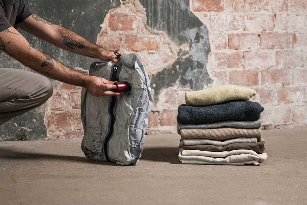 Roll-style vacuum bags compress clothes without needing a pump