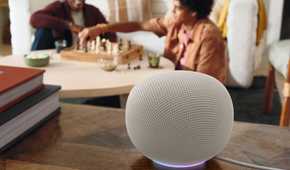 A Google Home Speaker in Porcelain sitting on a table.