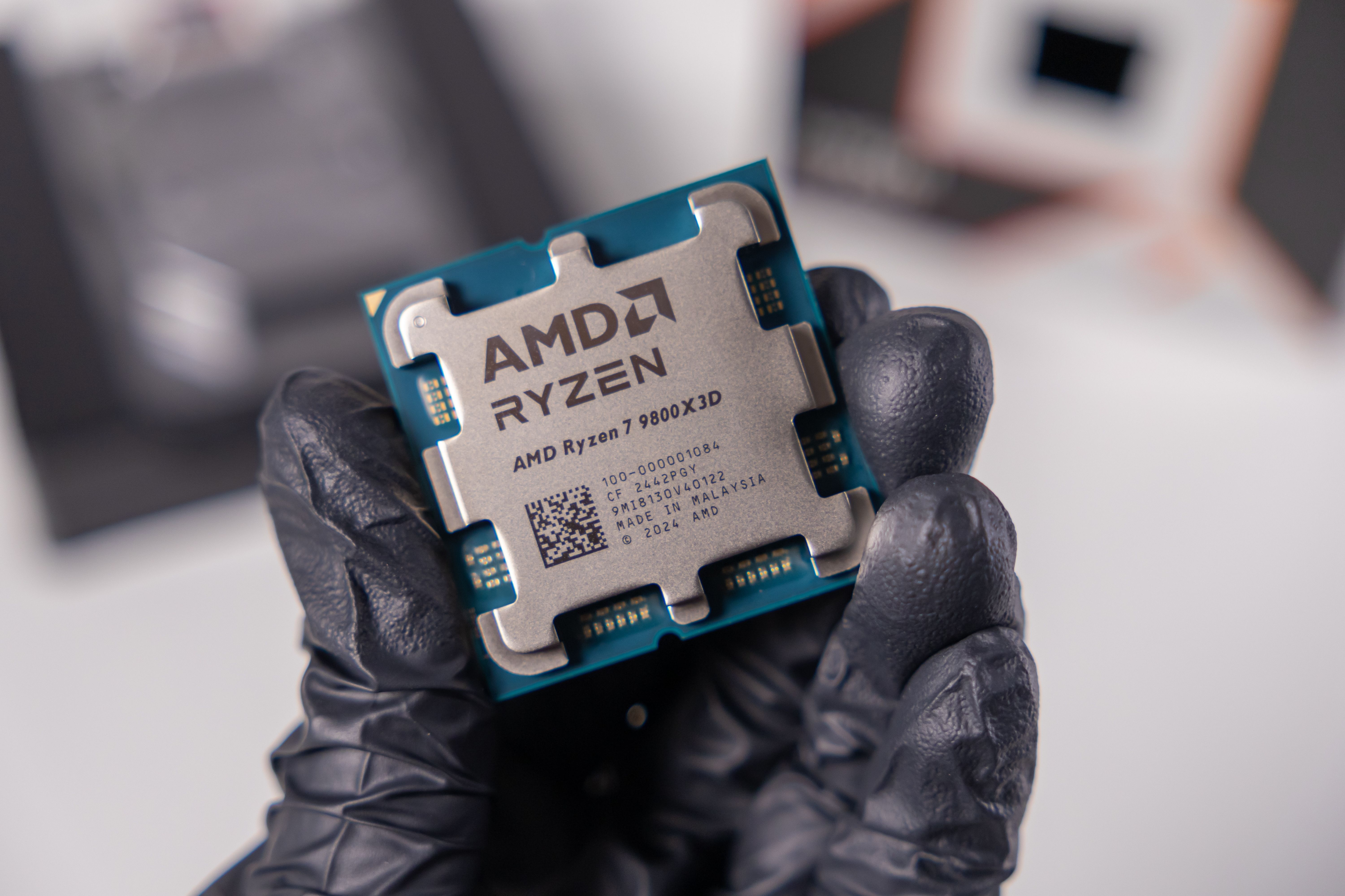 amd ryzen 7 9800x3d cpu held in hand.