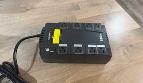 CyberPower 550VA UPS front angle view on wood desk