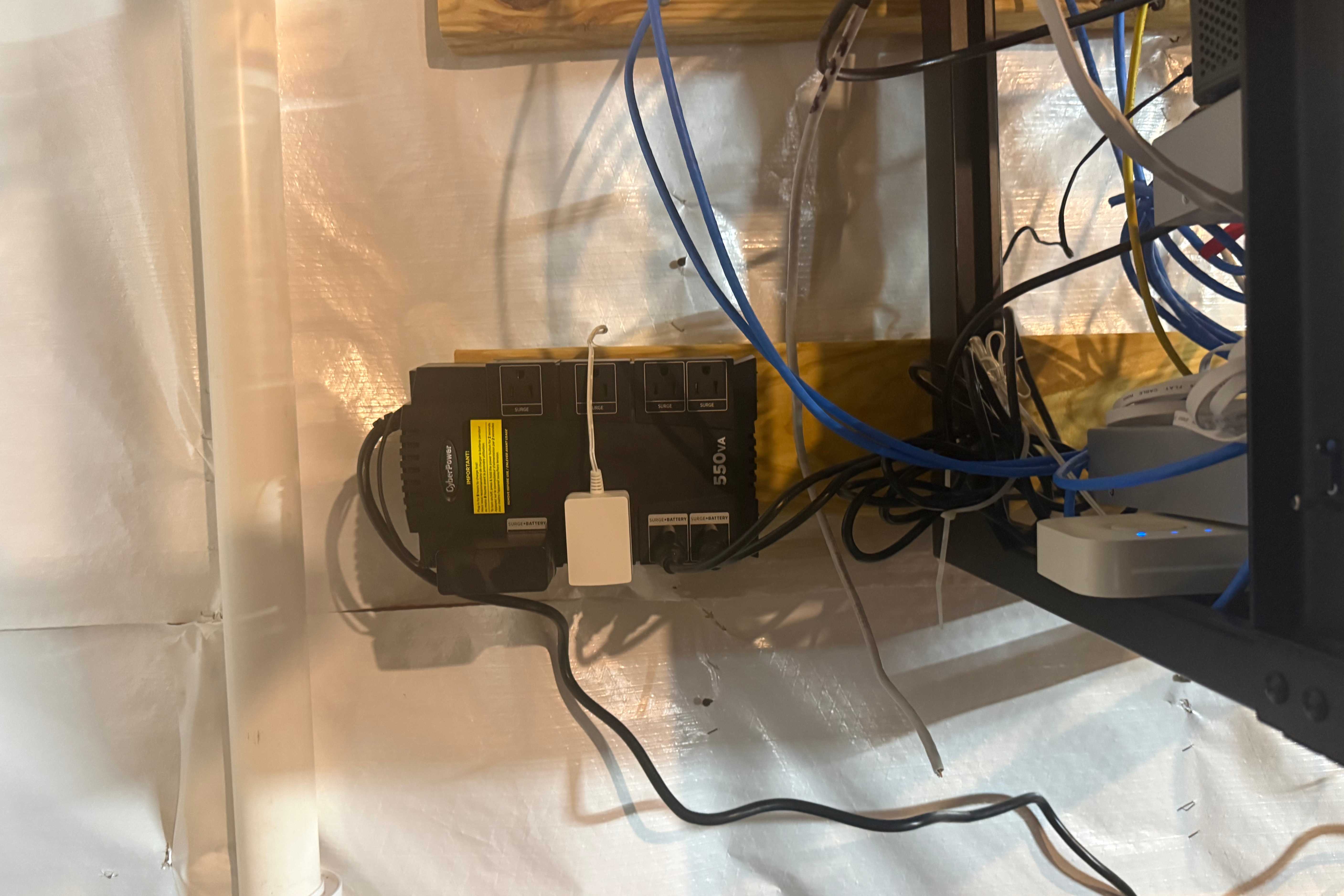 CyberPower 550VA UPS mounted near networking cables