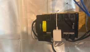 CyberPower 550VA UPS wall-mounted with outlets in use