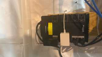 CyberPower 550VA UPS wall-mounted with outlets in use