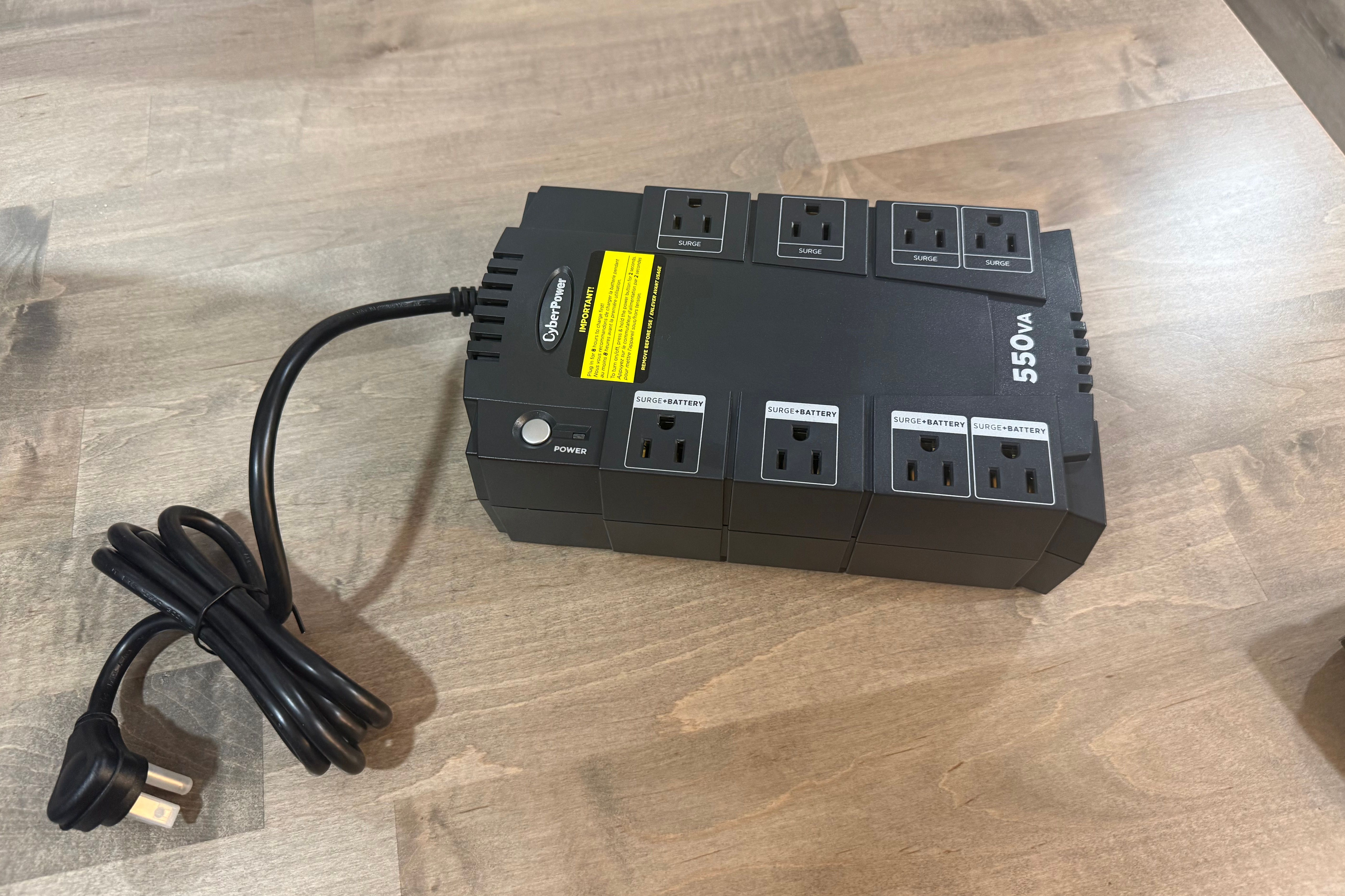 CyberPower 550VA UPS with coiled power cord on desk