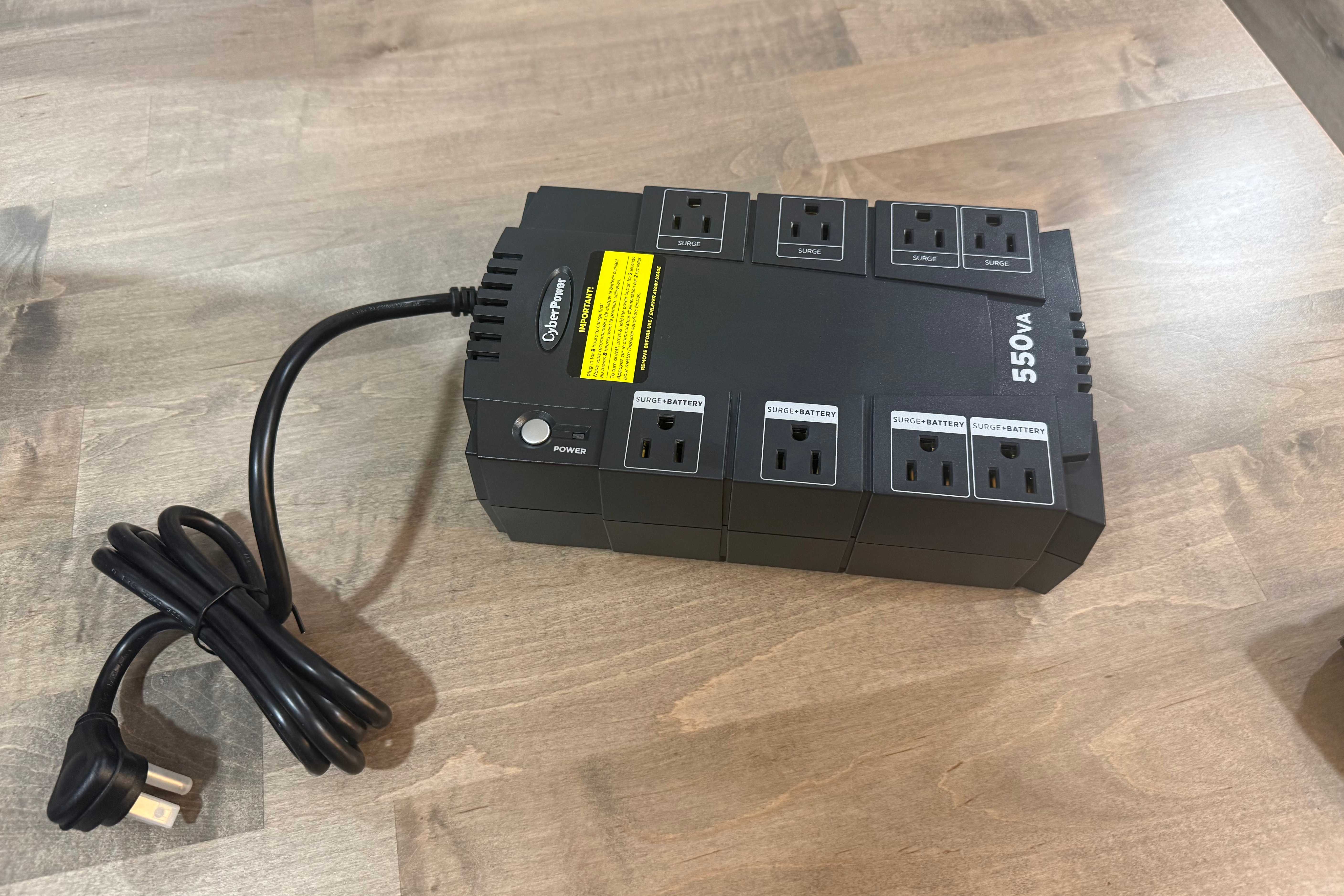 CyberPower 550VA UPS with coiled power cord on desk